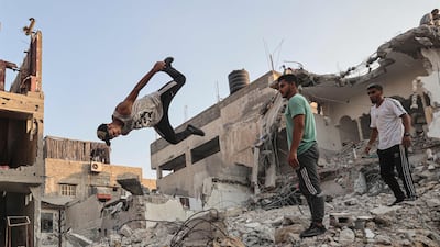Palestinian youths practise parkour amid the rubble of buildings destroyed by Israeli air strikes in the latest round of fighting between Israel and Palestinian militants, in Rafah in the southern Gaza Strip.