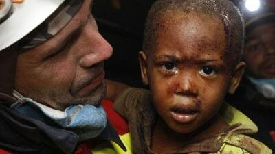 Two year old Redjeson Hausteen Claude reacts to his mother Daphnee Plaisin, after he is rescued from a collapsed home by Belgian and Spanish rescuers in the aftermath of the powerful earthquake in Port-au-Prince, on Thursday, January 14, 2010.