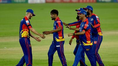 Karachi Kings' Mohammad Amir, second left, celebrates after clinching a Super Over win in the first PSL qualifier against Multan Sultans at National Stadium in Karachi on Saturday. AP