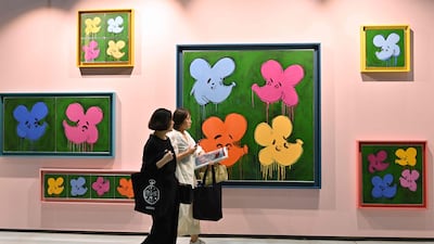 Visitors walk past an artwork named "Who are the Flowers?, 2023" by artist Simon Fujiwara during the Frieze Seoul 2023 art fair in Seoul on September 6, 2023. (Photo by Jung Yeon-je / AFP) / RESTRICTED TO EDITORIAL USE - MANDATORY MENTION OF THE ARTIST UPON PUBLICATION - TO ILLUSTRATE THE EVENT AS SPECIFIED IN THE CAPTION