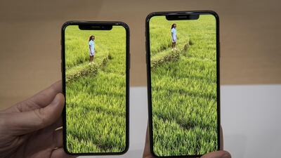 An attendee displays the Apple Inc. iPhone XS Max, right, and iPhone XS. David Paul Morris / Bloomberg