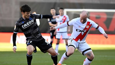 Real Sociedad's David Silva battles with Rayo Vallecano's Isi Palazon. AFP