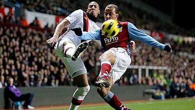 Aston Villa's Gabriel Agbonlahor, right, tussles with Manchester City's Jerome Boateng.