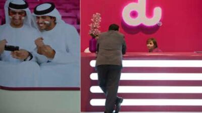 A man speaks to a Du representative during the Mecom 2008 Exhibition, Conference & Summit at the Abu Dhabi National Exhibition Centre.