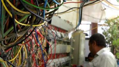 An electrician checks a generator used by a block of flats in Iraq as a back-up to the national grid.