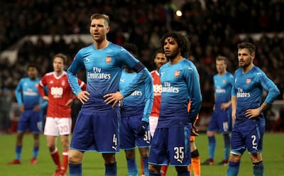 Arsenal's Per Mertesacker and Mohamed Elneny look dejected after being dumped out of the FA Cup by Championship side Nottingham Forest. Mike Egerton / AP Photo