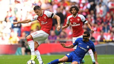 Chelsea's Pedro tackles Arsenal's Granit Xhaka. Tony O'Brien / Reuters
