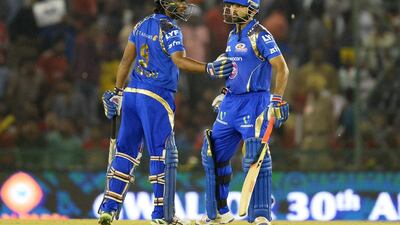 Ambati Rayudu, left, congratulates Parthiv Patel on reaching his half-century. Rayudu scored one, too. Sajjad Hussain / AFP