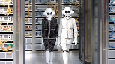 Models wearing tweed and plastic heads walk the runway in Chanel's spring/summer 2017 collection. Photo: Chanel
