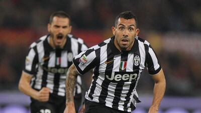 Carlos Tevez celebrates after scoring a free-kick against Roma on March 2. Paolo Bruno / Getty