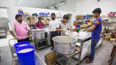 Cooks portion up the kanji that they will hand out to fasting Muslims in Deira.