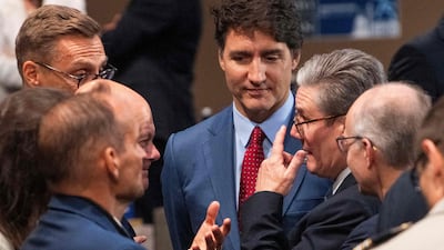 British Prime Minister Keir Starmer, right, speaks with Canadian Prime Minister Justin Trudeau, centre, and German Chancellor Olaf Scholz before the first working meeting of the Nato summit. AFP