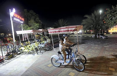 Children ride on rented bicycles. Satish Kumar for The National