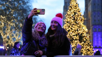 Ice skaters take a selfie on the ice rink at the Natural History Museum in central London. AFP