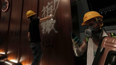 A protesters sprays graffiti onto the wall of the parliament chamber. AFP