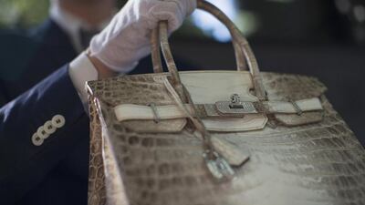 An employee holds an Hermes diamond and Himalayan Nilo Crocodile Birkin handbag at Heritage Auctions offices in Beverly Hills, California September 22, 2014. The handbag has 242 diamonds with a total of 9.84 carats. Reuters