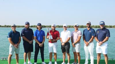 From left, Viktor Hovland, Shane Lowry, Tommy Fleetwood, Tyrrell Hatton, Rory McIlroy, Collin Morikawa, Adam Scott, and Lee Westwood pose with the tournament trophy ahead of the Abu Dhabi HSBC Championship at Yas Links Golf Course. Getty