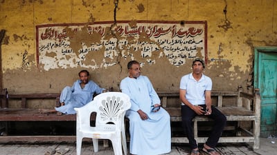 These men sit among the calligraphy at Aswan Institute of Hotel and Tourism Management and Computers in El-Sabaeiya