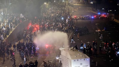 Thousands of protesters clash with the police as they block a highway in Tel Aviv. AFP