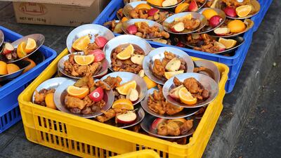 Hundreds and even thousands of worshippers enjoy a generous mix of dates, fresh fruits, laban, mandy, kebabs, muttom and chicken biryani provided by mosques and volunteers. Pawan Singh / The National