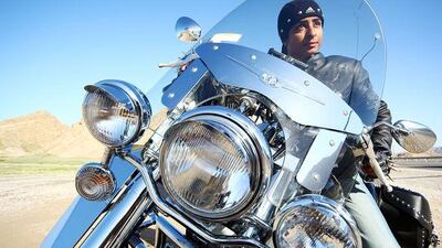 The only licensed female motorcyclist in the Sultanate of Oman, Nashwa al Kindy next to her Yamaha V-Star 650cc motorcycle.