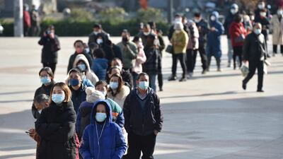 Residents line up outside a pharmacy to buy Covid-19 test kits in Nanjing, eastern China. Reuters