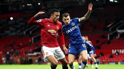 United's Mason Greenwood and Everton full-back Lucas Digne battle for the ball. PA