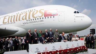 Sheikh Ahmed bin Saeed and Mr Enders sign an agreement confirming that Emirates is to purchase more Airbus A380 aircraft, as German Chancellor Angela Merkel looks on at the Berlin Airshow in 2010. Getty Images