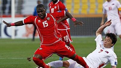 The UAE's Al Wahda winger Ismail Al Hammadi, left, is fouled by North Korea's Ryang Yong-gi.