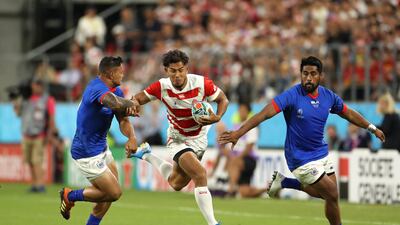 Ryohei Yamanaka of Japan holds off Alapati Leiua and Ah See Tuala at the City of Toyota Stadium. Getty