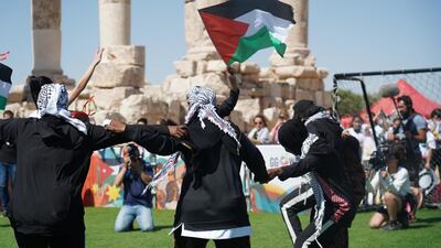 Football players from Gaza camp dance Dabke on the field before their match. Amy McConaghy / The National