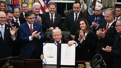 US President Donald Trump shows the signed bill package to re-open the federal government in the Oval Office of the White House in Washington. AFP