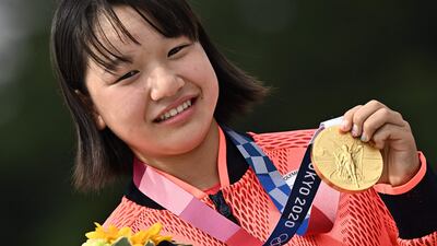 Japan's Momiji Nishiya poses with her gold medal during the podium ceremony of the skateboarding women's street final of the Tokyo 2020 Olympic Games at Ariake Sports Park.