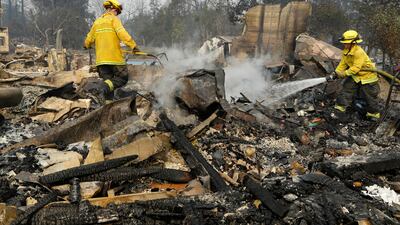 Firefighters douse hot spots in the Coffey Park area of Santa Rosa, California. Ben Margot / AP Photo