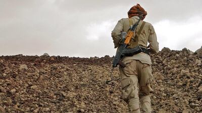 A fighter loyal to Yemen's Saudi-backed government mans a position near the front line facing Iran-backed Houthi rebels in Marib province. AFP