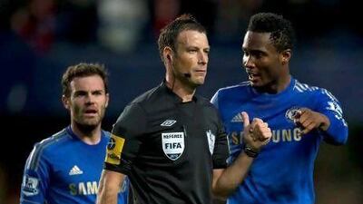 Mark Clattenburg, middle, was accused using a racial slur towards John Obi Mikel, right, during the game on Sunday.