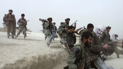 Afghan opposition Northern Alliance soldiers leap over a trench as they return from front line positions after battle near the town of Charatoy in the north of Afghanistan October 10, 2001. REUTERS