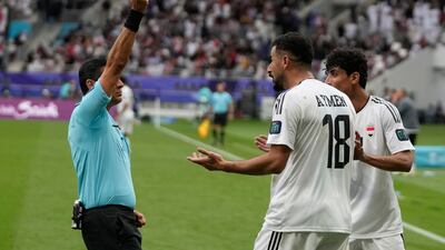 Iraq's Aymen Hussein is shown a second yellow card. AP