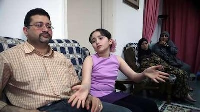 Rihab Issa, 10, in her living room with father, Baqer Abdulaziz. Rihab hopes to study computer science. Her school, Al Jemaiyah School, was closed last June, along with several other schools in the region.