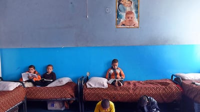 In this photograph taken on December 17, 2014, Afghan children read their school books as they sit in their bunk beds at the Halwdin government orphanage in Kabul. International aid was meant to transform Afghanistan's welfare standards, but orphanages in Kabul reveal that the most vulnerable children, many left parentless by war, have seen little benefit from the billions of dollars spent. Wakil Kohsar/AFP Photo