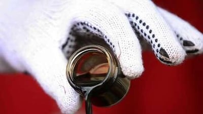 Oil's outpouring: Venezuela's president Hugo Chavez takes a sample of crude oil.