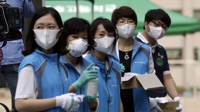 South Korean health workers from a community health centre wearing masks as a precaution against Mers as the death toll from the virus rose to 16 on Monday. Lee Jin-man/AP Photo