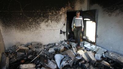 A relative inspects the house of Amer Abu Eishe. Israel has vowed to make Hamas pay for the murders, but the Islamist movement warned any reprisal attacks would open ‘the gates of hell’. Hazem Bader/AFP Photo