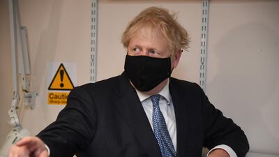 Prime Minister Boris Johnson wears a face mask as he visits Tollgate Medical Centre in Beckton on July 24, 2020, in London. Getty Images