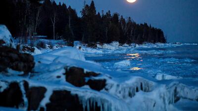 The moon rises over the ice on the shore of Lake Superior, in Lutsen, Minnesota. AP Photo