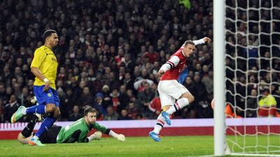 Left midfield: Lukas Podolski, Arsenal. The German displayed his predatory instinct by scoring twice against Coventry to set up a tie with Liverpool. Facundo Arrizabalaga / EPA
