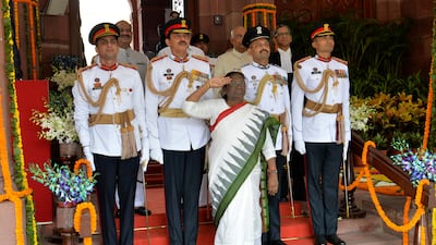 Ms Murmu salutes troops during her swearing-in ceremony in New Delhi. AP