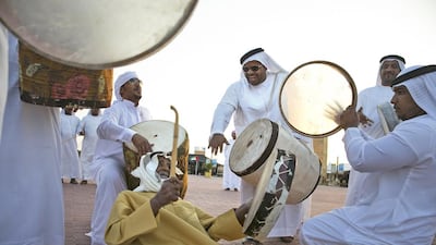 Hilal Kadim al Kaabi (centre)of Al Ain, beats his drum while he performs with the Banikaab, a drum and al yolla group based in Al Ain, at the fourth annual Zayed Heritage Festival. Silvia Razgova / The National