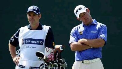Lee Westwood of England stands with his caddie Billy Foster.