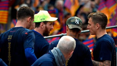 Lionel Messi, second left, and teammates during the open-top bus celebrations. Lluis Gene / AFP